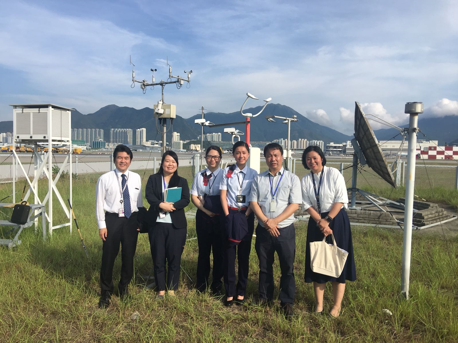 Figure 1: A group photo of visitors from Japan Airlines with the Observatory's Chief Experimental Officer, Mr. PS Ho (second from right) taken in the Meteorological Enclosure