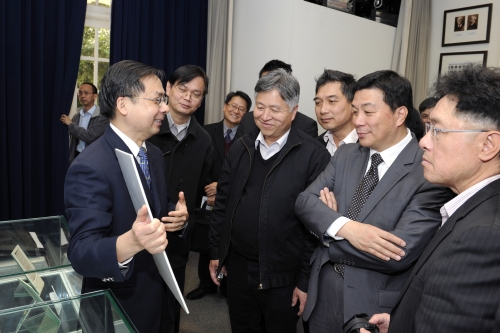 A delegation of 14 members from Wong Tai Sin District Council, headed by the Chairman of the District Council Mr LI Tak-hong (2nd right) listening to the Director briefing on the history of the Observatory.