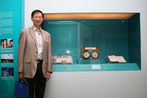 Professor Yau standing in front of the 1966 'World Today' magazine, one of the exhibits of the 'Hong Kong Observatory - Under the Same Sky 130 Years' exhibition at the Hong Kong Museum of History.