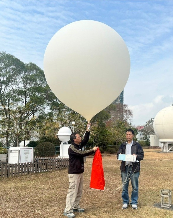Hong Kong Observatory staff releasing a weather balloon carrying a cryogenic frostpoint hygrometer to precisely measure upper-air water vapour content.